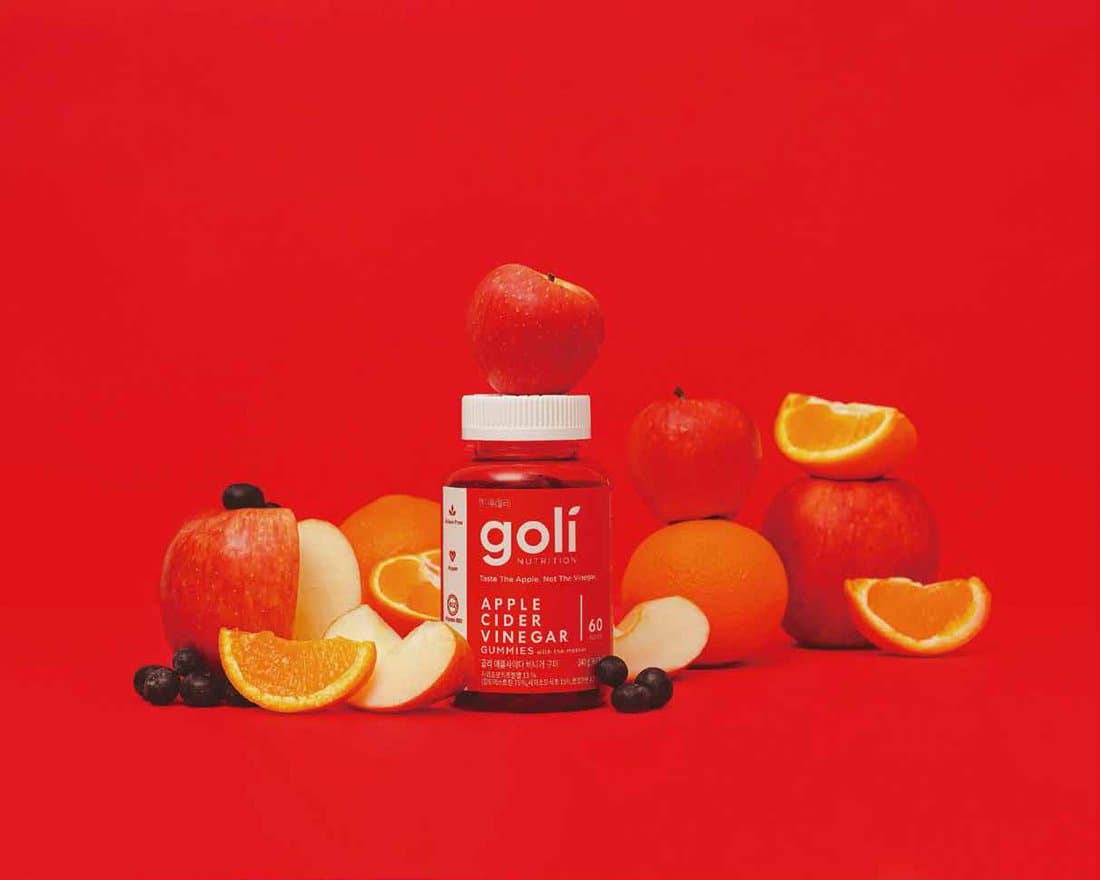 GOLI bottle with apple, orange, and berries